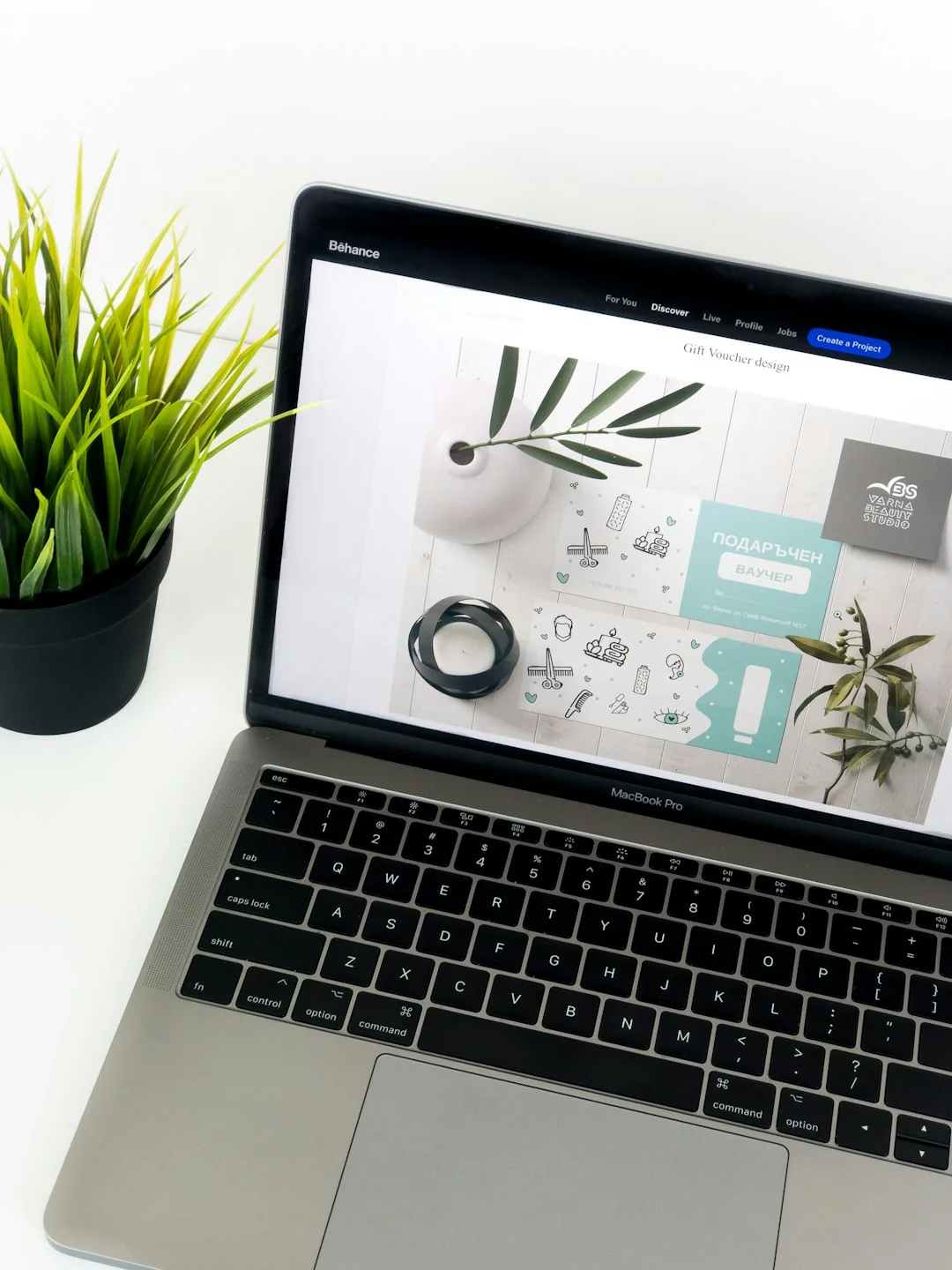 A modern computer screen displaying web design work, showcasing creative visuals in a workspace.